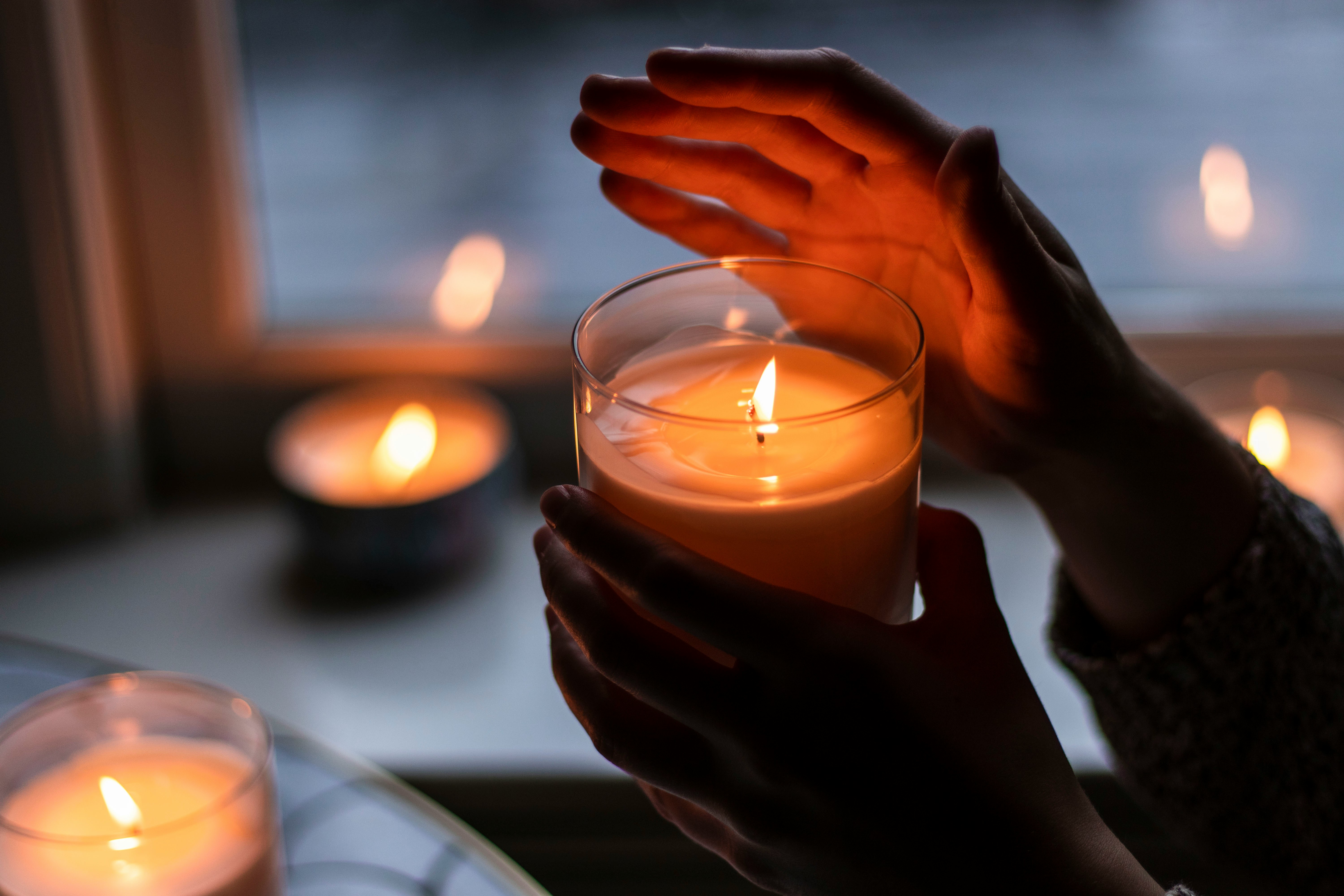 A single candle flame — the indelible trace of light